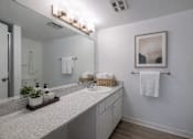 Thumbnail 8 of 31 - A bathroom with a white counter top and a white sink.