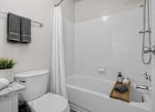 Thumbnail 30 of 87 - Bathroom with white subway tile and gray accents at Village Club of Farmington Hills Apartments, Michigan