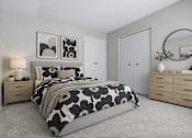 Thumbnail 27 of 87 - Bedroom with floral bedding and natural wood furniture at Village Club of Farmington Hills Apartments, Michigan, 48331