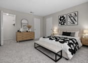 Thumbnail 21 of 87 - Stylish bedroom with upholstered headboard and floral bedding at Village Club of Farmington Hills Apartments, Farmington Hills, MI 48331
