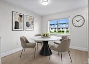 Thumbnail 3 of 14 - A dining room with a table and chairs.