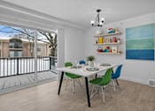 Thumbnail 15 of 38 - A dining room with a white table and green chairs.