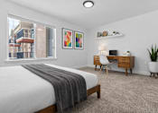 Thumbnail 19 of 38 - A bedroom with a bed, desk, and chair.