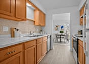 Thumbnail 12 of 38 - A kitchen with wooden cabinets and a white refrigerator.