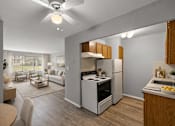 Thumbnail 6 of 33 - A modern kitchen with a refrigerator, stove, and sink.