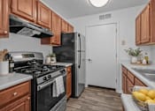 Thumbnail 1 of 43 - A kitchen with a black stove and a black refrigerator.