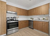 Thumbnail 12 of 31 - A kitchen with wooden cabinets and stainless steel appliances.