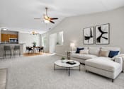 Thumbnail 28 of 87 - Spacious living room with vaulted ceiling and dining area at Village Club of Farmington Hills Apartments, Farmington Hills, MI 48331