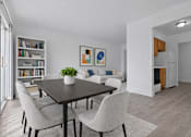 Thumbnail 13 of 38 - A dining room with a table and chairs.