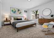 Thumbnail 17 of 38 - A bedroom with a bed, nightstands, and a chair.