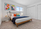Thumbnail 20 of 38 - A bedroom with a bed, two lamps, and two framed pictures on the wall.