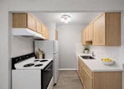 Thumbnail 7 of 33 - A kitchen with a white stove and wooden cabinets.