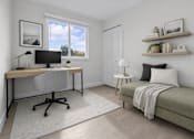 Thumbnail 9 of 14 - A room with a desk, chair, and bed.