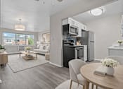 Thumbnail 2 of 33 - A modern kitchen with a dining table set for two.