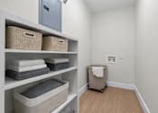 Thumbnail 12 of 14 - A laundry room with a washer and dryer.