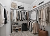 Thumbnail 24 of 87 - Walk-in closet with organized storage and neutral tones at Village Club of Farmington Hills Apartments, Michigan
