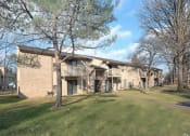 Thumbnail 1 of 25 - a building with a grassy area in front of it