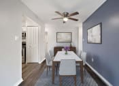 Thumbnail 13 of 34 - a dining room with a table and chairs and a ceiling fan