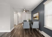 Thumbnail 15 of 34 - a dining room with a table and chairs and a ceiling fan