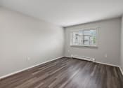 Thumbnail 27 of 34 - an empty room with wood floors and a window