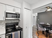 Thumbnail 4 of 34 - a kitchen with a stove and a microwave