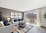 Thumbnail 9 of 34 - a living room with a sliding glass door to a balcony