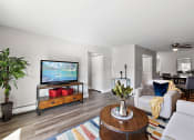 Thumbnail 10 of 34 - a living room with a couch and a tv