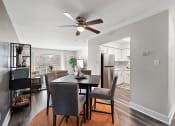 Thumbnail 14 of 34 - a living room with a dining room table and a ceiling fan
