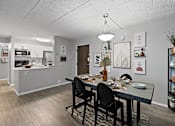 Thumbnail 6 of 25 - A dining room with a table set for four.
