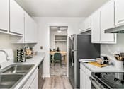 Thumbnail 109 of 116 - A kitchen with white cabinets and a black refrigerator at The Waverly on the Lake - Belleville, MI Apartment , Michigan