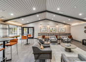 Thumbnail 57 of 116 - A spacious waiting area with a variety of seating options and artwork on the walls at The Waverly on the Lake - Belleville, MI Apartment , Michigan, 48111