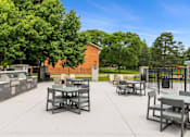 Thumbnail 69 of 116 - A park with tables and chairs and a fence at The Waverly on the Lake - Belleville, MI Apartment, Belleville, MI, 95050