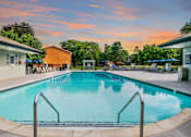 Thumbnail 77 of 116 - A large swimming pool with a metal ladder in the foreground at The Waverly on the Lake - Belleville, MI Apartment , Belleville, MI