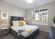 Thumbnail 6 of 39 - A bedroom with a large bed and a window with blinds.