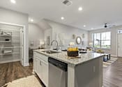 Thumbnail 1 of 39 - A modern kitchen with a granite countertop and stainless steel appliances.