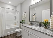 Thumbnail 5 of 39 - A bathroom with a white toilet, a white sink, and a white bathtub.