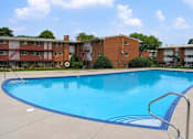 Thumbnail 14 of 17 - A swimming pool in front of a building.