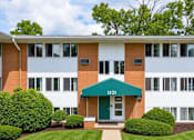 Thumbnail 16 of 17 - A building with a green awning and the number 1121 on it.