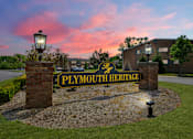 Thumbnail 33 of 33 - A sign that says "Plymouth Heritage" is in front of a building.