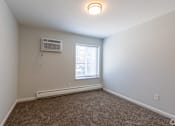 Thumbnail 28 of 44 - A room with a window, carpet, and an air conditioner. at The Park on 13 Apartments - Royal Oak, MI Apartments, Michigan