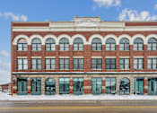 Thumbnail 19 of 21 - A red brick building with a white sign on the top.
