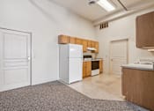 Thumbnail 1 of 21 - A kitchen with white appliances and wooden cabinets.
