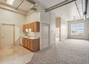 Thumbnail 2 of 21 - A kitchen area with a refrigerator, sink, and cabinets.