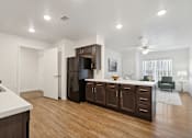 Thumbnail 2 of 18 - an open kitchen and living room with a refrigerator and a sink