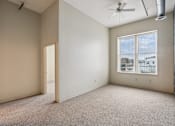 Thumbnail 10 of 21 - Empty room with a window and a ceiling fan.