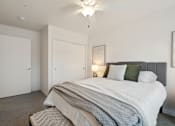 Thumbnail 6 of 18 - a bedroom with a large bed and a ceiling fan