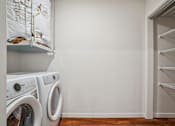 Thumbnail 18 of 23 - A laundry room with a washer and dryer.