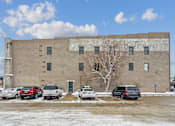 Thumbnail 21 of 21 - A large building with a tree in front of it.