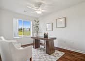 Thumbnail 11 of 23 - A room with a table, chairs and a ceiling fan.