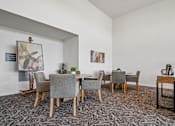 Thumbnail 3 of 23 - A dining room with a table and chairs.